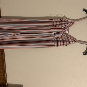 Long pants romper pink blue white and black stripes. Bow in front.